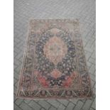 A Perisan design rug with blue ground and central pink medallion 195 x 122cm
