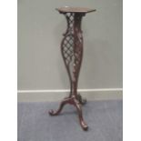 A rococo style mahogany torchere,