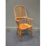 A 19th century style elm and burr elm seat hoop back windsor armchair, the broad arm rests over