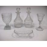 A pair of cut glass decanters and stoppers, with ribbed necks, 25cm high; a hobnail cut pedestal