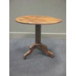 A 19th century circular inlaid tilt-top table on column and tripod base, 69cm high 83cm diameter