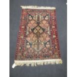 A modern Heriz style patterned rug with geometric medallions and floral border, 228 x 137cm