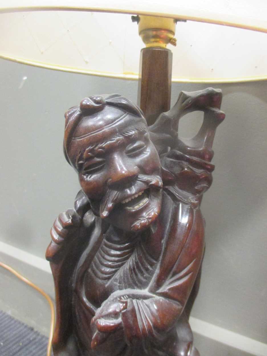 A Chinese carved wood figure adapted into a lamp base together with a French lamp and a pair of - Image 3 of 9