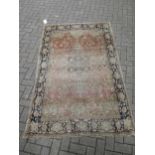 A Perisan design floral rug with pale red ground (worn) 208 x 133cm