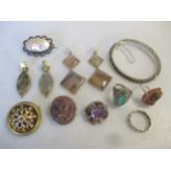 A collection of jewellery including a stone set bangle, four brooches, two pair of earrings and