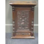 A 19th century continental carved walnut wall cupboard, with drawers and compartments, key