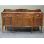 A 19th century mahogany and satinwood strung breakfront rectangular sideboard, on square tapered and