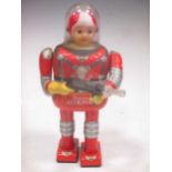 A Daiya for Cragstan Tinplate Battery operated Astronaut, A-620, holding a space gun, 35cm high