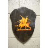 An early 20th century painted armorial shield of a Griffin, 34cm high, together with seven various