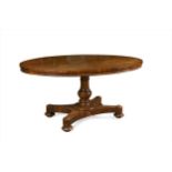 A late Regency rosewood breakfast table, the oval tilt top on tuned column and X shaped platform