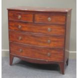 A George III figured mahogany bow fronted chest of two short and three long drawers, with bronzed