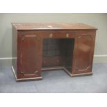 A 19th century mahogany desk, fitted with a drawers flanked by cupboards, the kneehole with ten