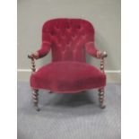 A Victorian rosewood button backed nursing chair, with barley twist arm surpports, upholstered in