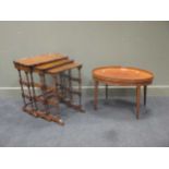 An oval mahogany coffee table with raised edge, a set of four Edwardian floral carved mahogany