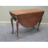 A George III mahogany oval drop leaf dining table,