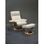 An EKORNES "stressless" leather recliner with drinks tray together with a matching footstool