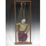 An early 20th century Japanese figure puppet within a wooden frame