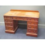 A Victorian mahogany pedesal desk with a gallery back above nine drawers on plinth base 77 x 122 x