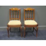 A pair of continental fruitwood chairs with shaped back, triple splats, upholstered seats on