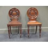 A pair of Victorian mahogany hall chairs