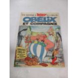 A box of Asterix stories in French, published c.1960s and 1970s, some with taped repairs