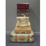 Collection of 6 leather and other suitcases, including one miniature cabin trunk and one vellum case