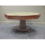 A 19th century octagonal mahogany library table with green leather inset top, four real and four