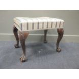 A George II style carved rectangular upholstered stool, 20th century,