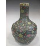 A Chinese bottle necked vase decorated with carnations and flora, 33cm high