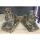A pair of reconstituted stone recumbent lions (2)
