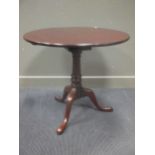 A George III mahogany birdcage circular tilt top table, the turned column over a tripod base 74cm