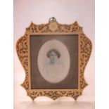 A 19th century carved Canton ivory photograph frame containing a portrait miniature on ivory,