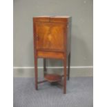 An early 19th century mahogany and shell inlaid washstand, the fold out top above a cupboard and