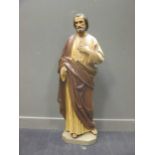 A 19th century carved wood and painted figure of St Peter 134cm high