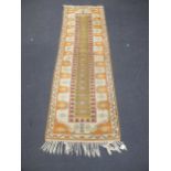 A tribal wool rug and small runner, later 20th century