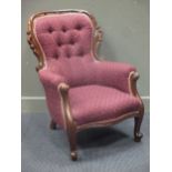 A late 19th century Australian cedar wood button back arm chair, the spoon back surrounded by a