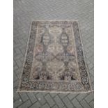 A Perisan design rug with blue ground and repeated stylised floral leaf patterns (worn in places)