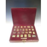 Two cased sets of silver gilt stamps, one 'The Empire Collection', the other 'The Royal Collection',
