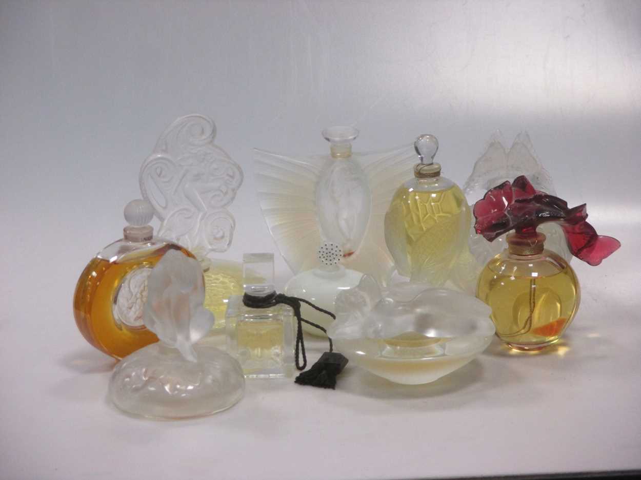 Twenty various 20th century Lalique perfume bottles