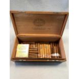 A wooden table cigar box (NOT a humidor), containing a large assortment of Cuban and other cigars