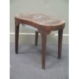 A George III mahogany kidney shaped bidet stool with creamware liner, 46 x 58 x 36cmFootnote: