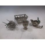 Four continental metalwares miniature items; a sleigh, basket, wheelbarrow and urn (4)