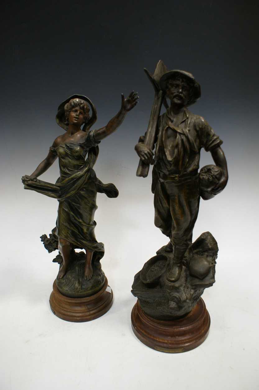 A pair of spelter figures of land workers, 50cm high and a near pair of similar spelter figures (4)