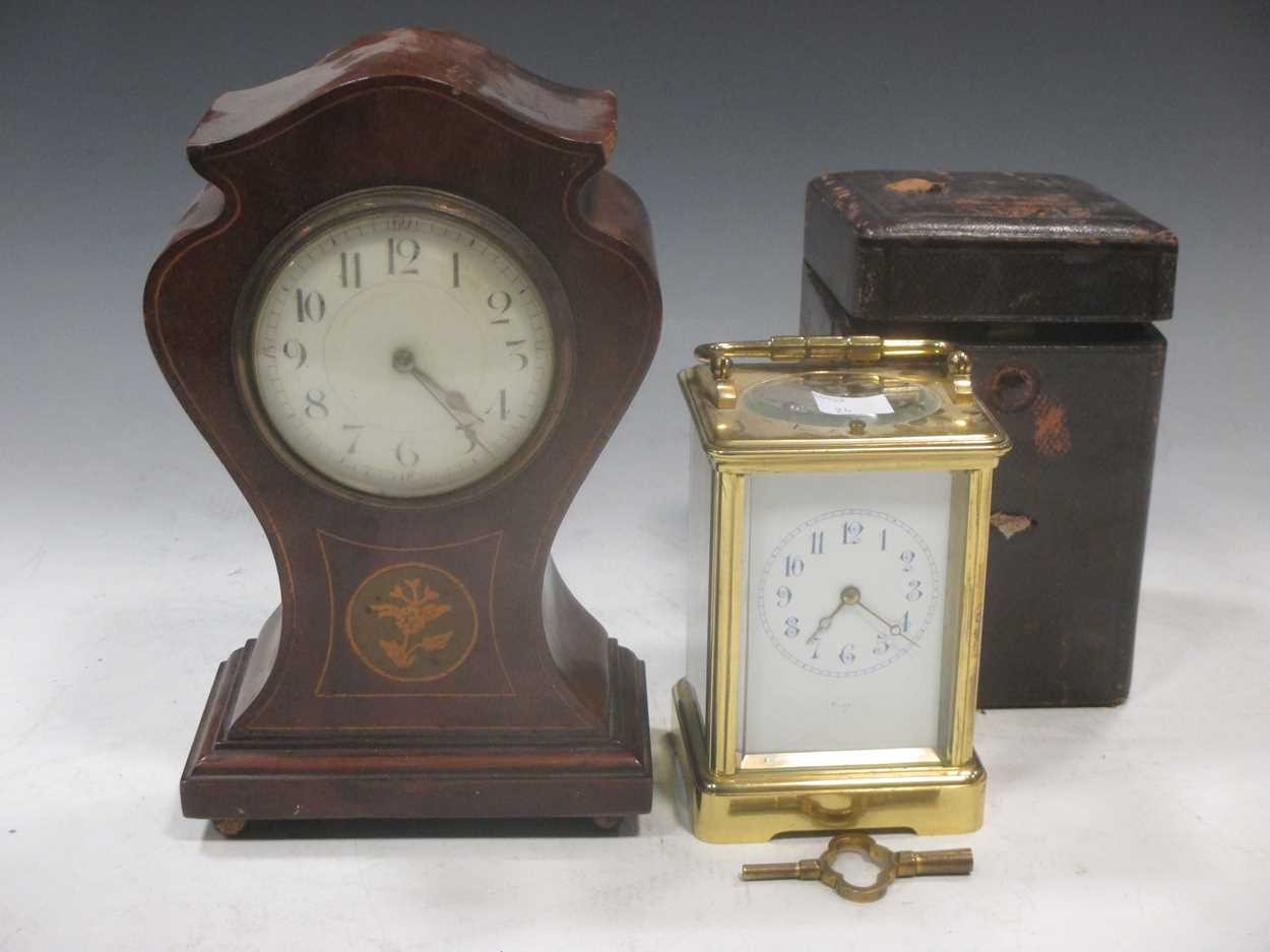 An Edwardian brass carriage clock with arabic numerals, the back stamped E M & Co, together with