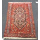 A Hamadan red and blue ground wool rug, 238 x 150cm