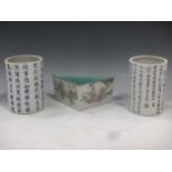 A near pair of early 20th century Chinese porcelain brush pots, decorated in blue with Chinese