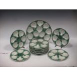 A set of twelve scallop plates, (two broken) together with a serving dish of the same design