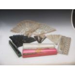 A collection of fans, including ivory, mother-of-pearl, tortoiseshell and others, many boxed