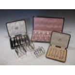 Two silver toast racks and two cased sets each of 6 silver teaspoons 10.7ozt together with a set