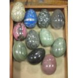 A collection of eleven 20th century hardstone eggs, each approx. 7cm